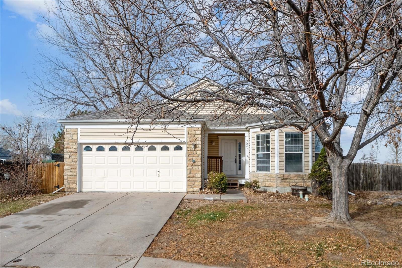 5241 Helena Street Denver, CO 80239 - Photo 24 of 28 a view of a house with a yard and large tree