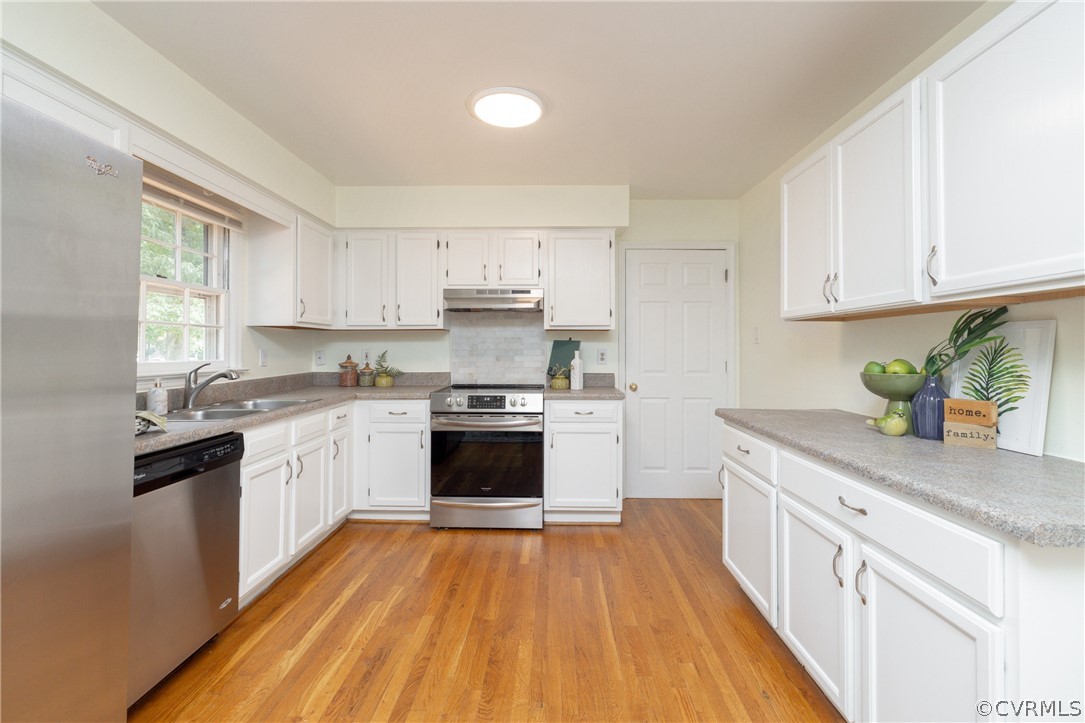 12000 Quito Road Midlothian, VA 23112 - Photo 13 of 36 a kitchen with a sink a counter top space stainless steel appliances and a window