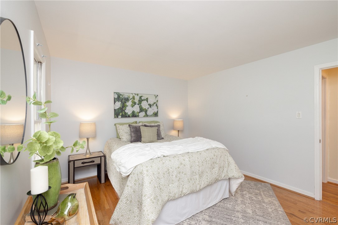 12000 Quito Road Midlothian, VA 23112 - Photo 19 of 36 a bedroom with a bed table flowerpot and window