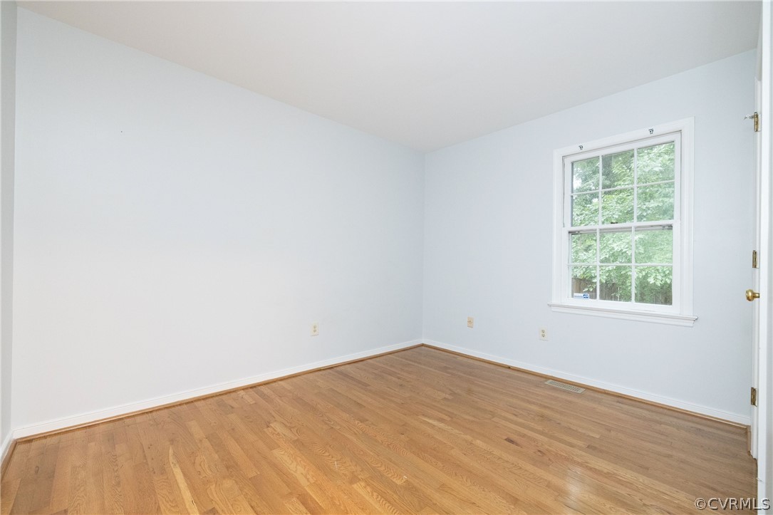 12000 Quito Road Midlothian, VA 23112 - Photo 20 of 36 an empty room with wooden floor and windows
