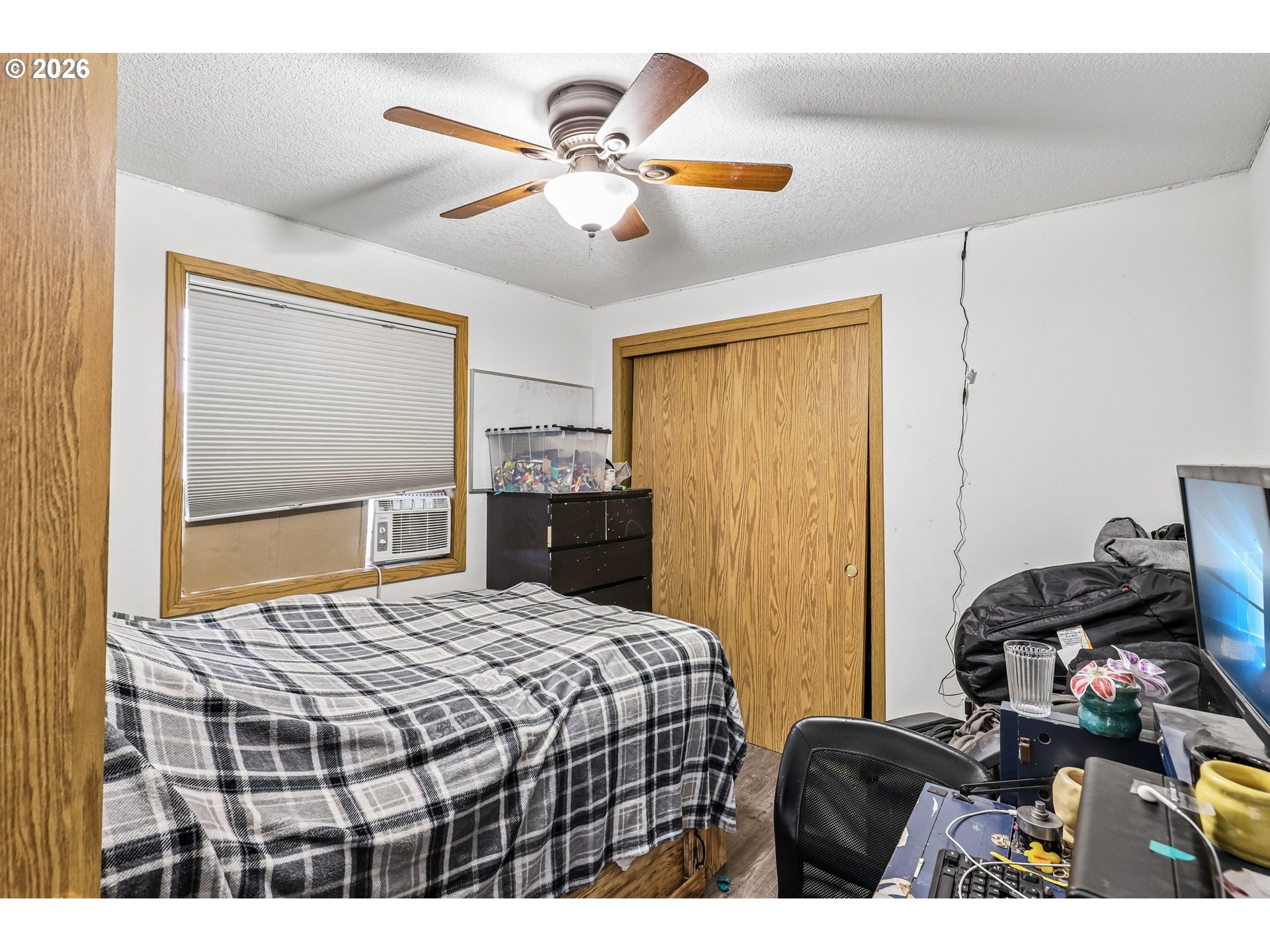 608 Southeast Sumner Street Camas, WA 98607 - Photo 14 of 39 a bedroom with a bed and a chandelier