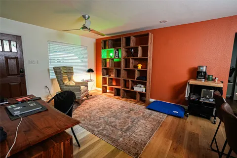 a bedroom with furniture and a book shelf