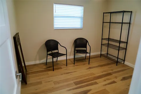 a view of a workspace with furniture and a window