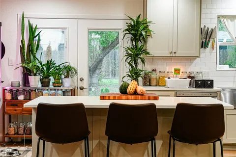 a dining room with furniture and a potted plant