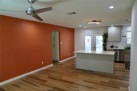 a living room with kitchen island furniture and a wooden floor