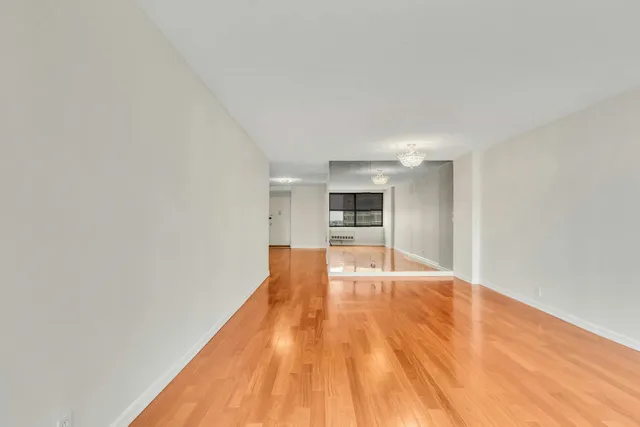 a view of a room with wooden floor and cabinet