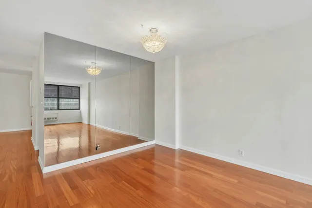 a living room with a bed furniture and a table