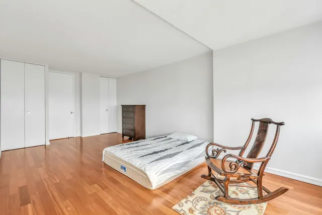 a bedroom with a bed and a large window