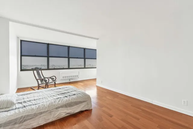 a living room with a bed furniture and a window