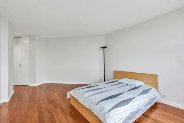 a bedroom with a bed and a rug