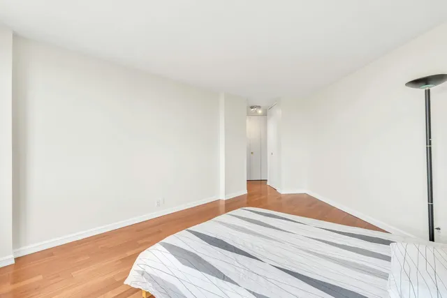 a bathroom with a granite countertop sink a toilet a mirror and shower