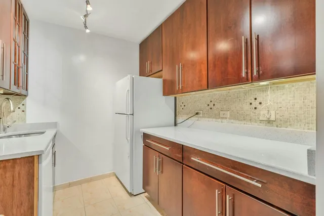 a kitchen with a sink a microwave a stove and refrigerator