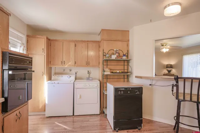 a view of a kitchen counter space and wooden floor