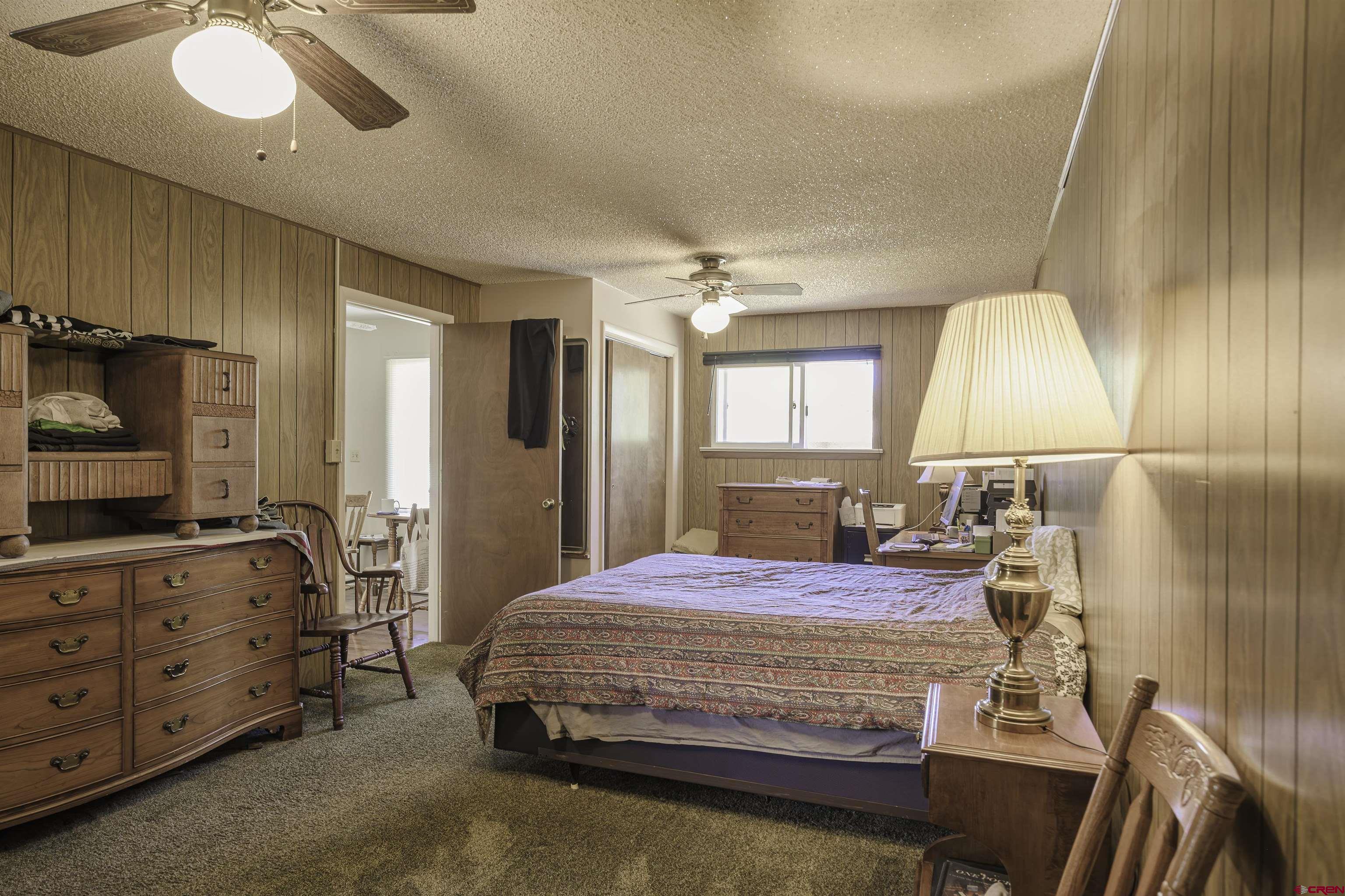 1002 East 2nd Street Florence, CO 81226 - Photo 17 of 44 a bedroom with a bed and wooden floor