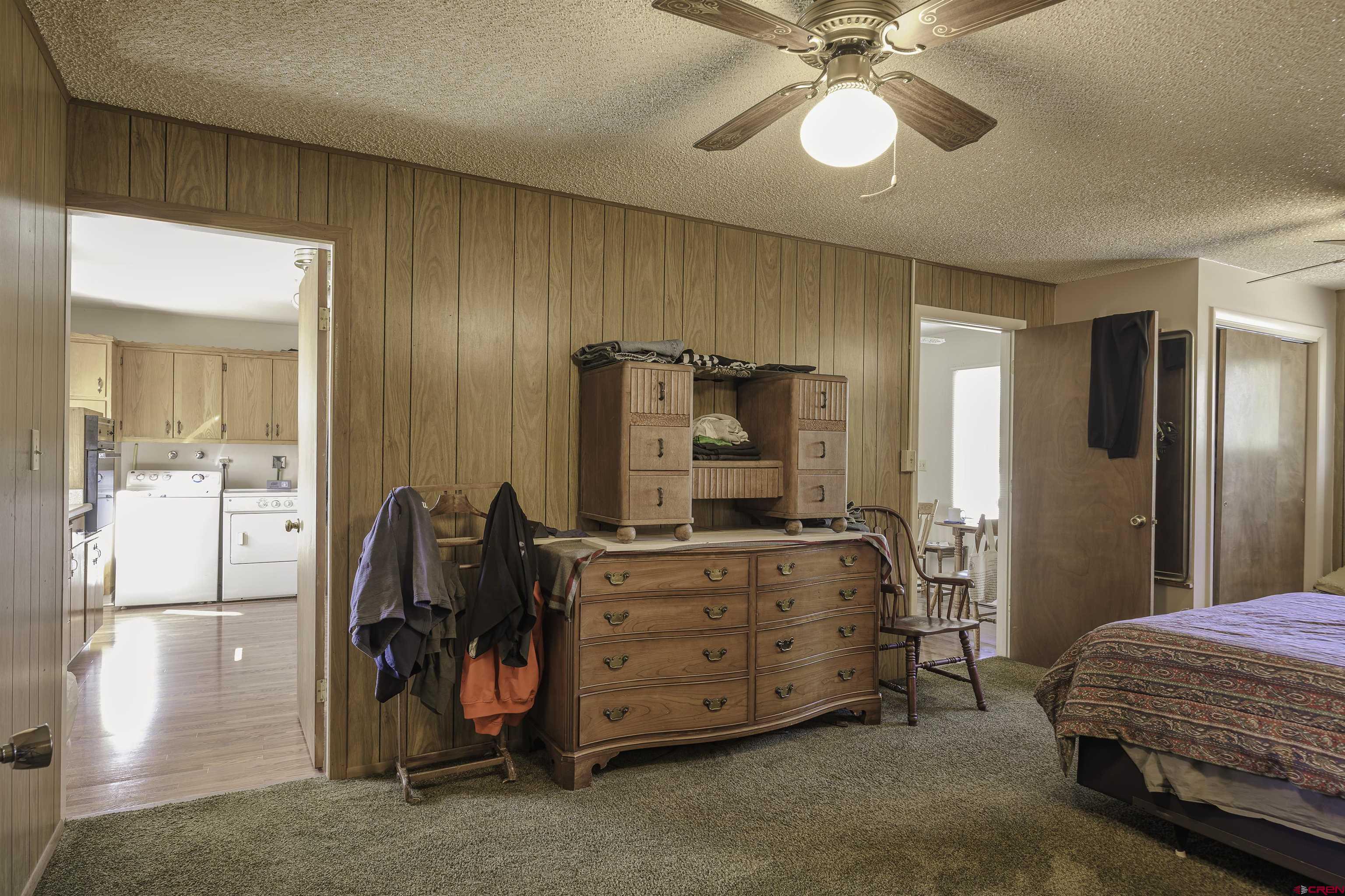1002 East 2nd Street Florence, CO 81226 - Photo 19 of 44 a bedroom with a bed and a chandelier