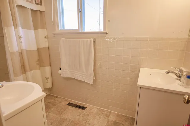 a bedroom with a bed lamp and a window