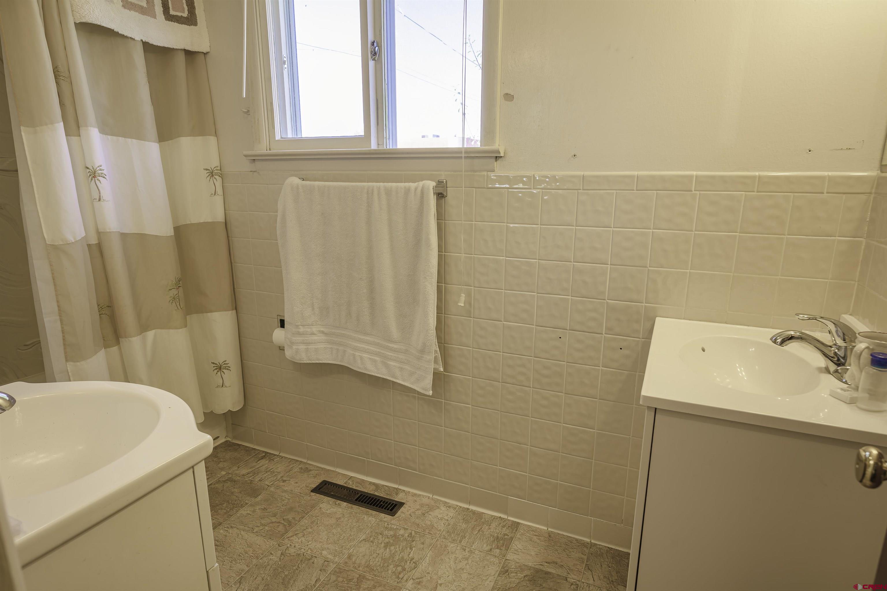 1002 East 2nd Street Florence, CO 81226 - Photo 21 of 44 a bathroom with a sink and a shower