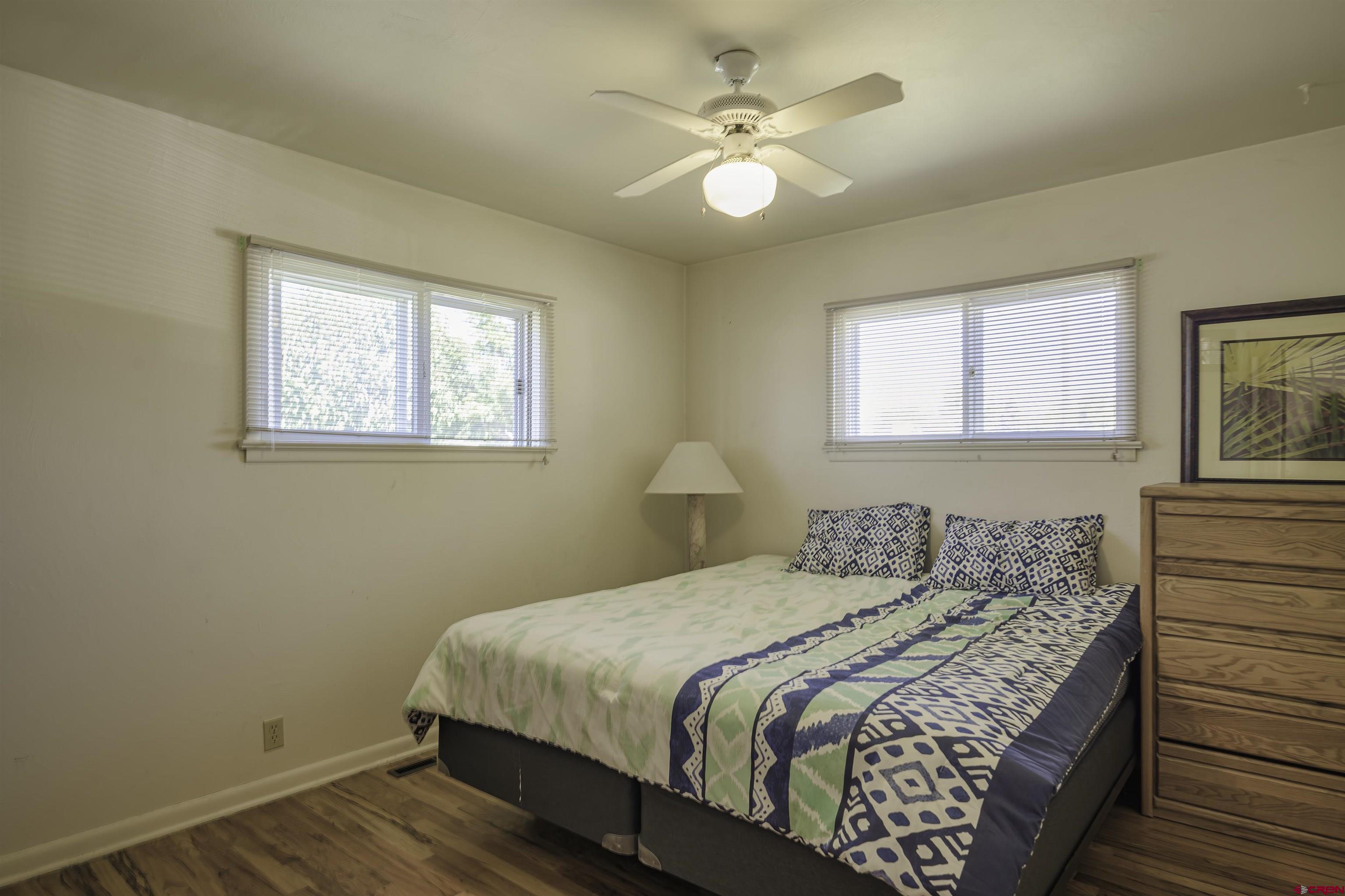 1002 East 2nd Street Florence, CO 81226 - Photo 22 of 44 a bedroom with a bed lamp and a window