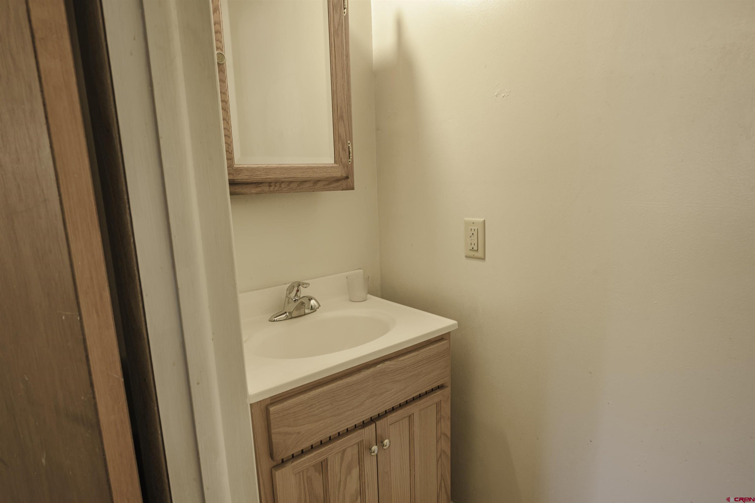 1002 East 2nd Street Florence, CO 81226 - Photo 26 of 44 a bathroom with a sink a vanity and a mirror
