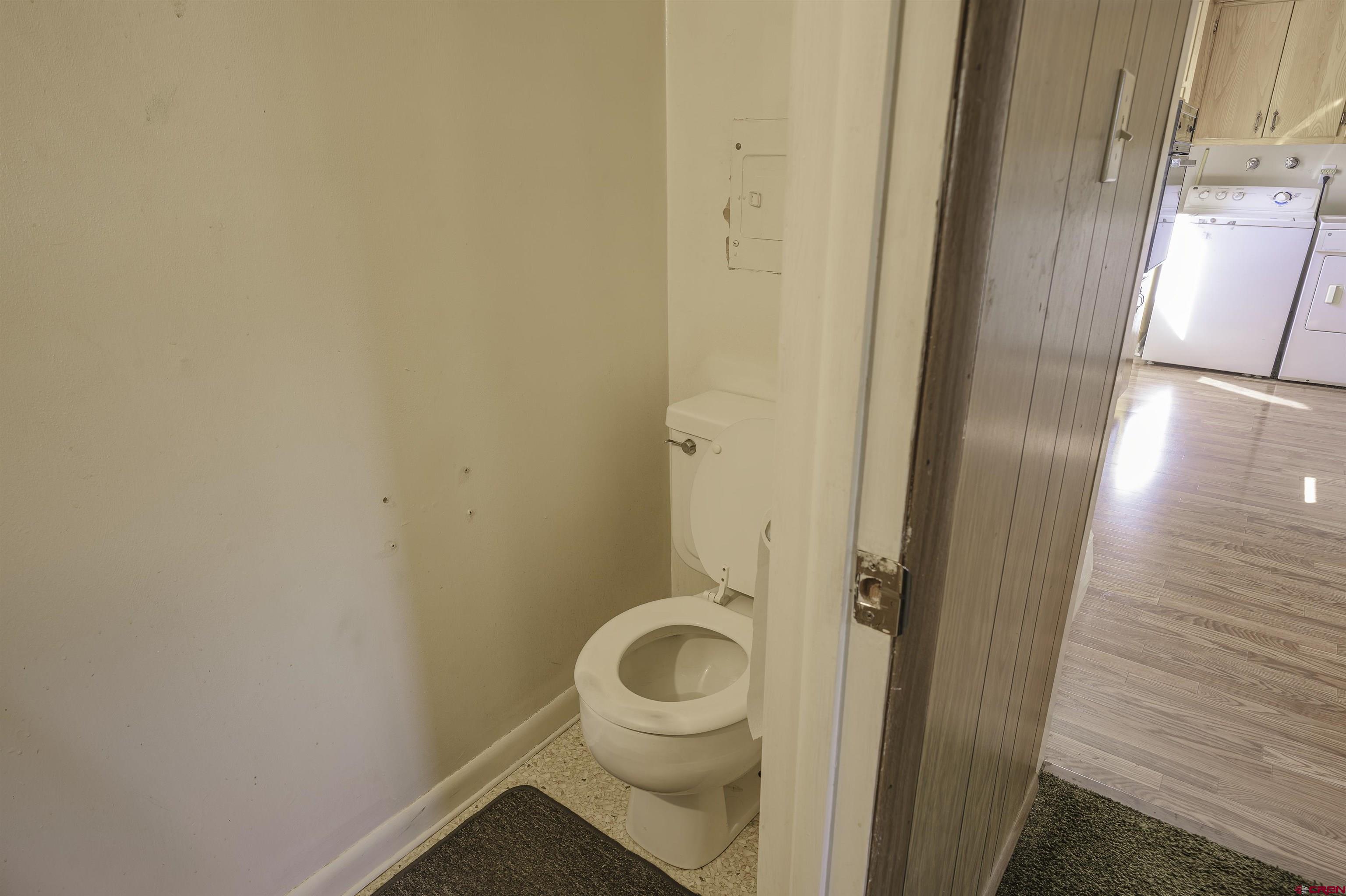 1002 East 2nd Street Florence, CO 81226 - Photo 27 of 44 a bathroom with a granite countertop toilet and a sink