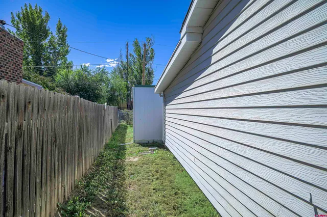 a view of a backyard with a patio and fire pit