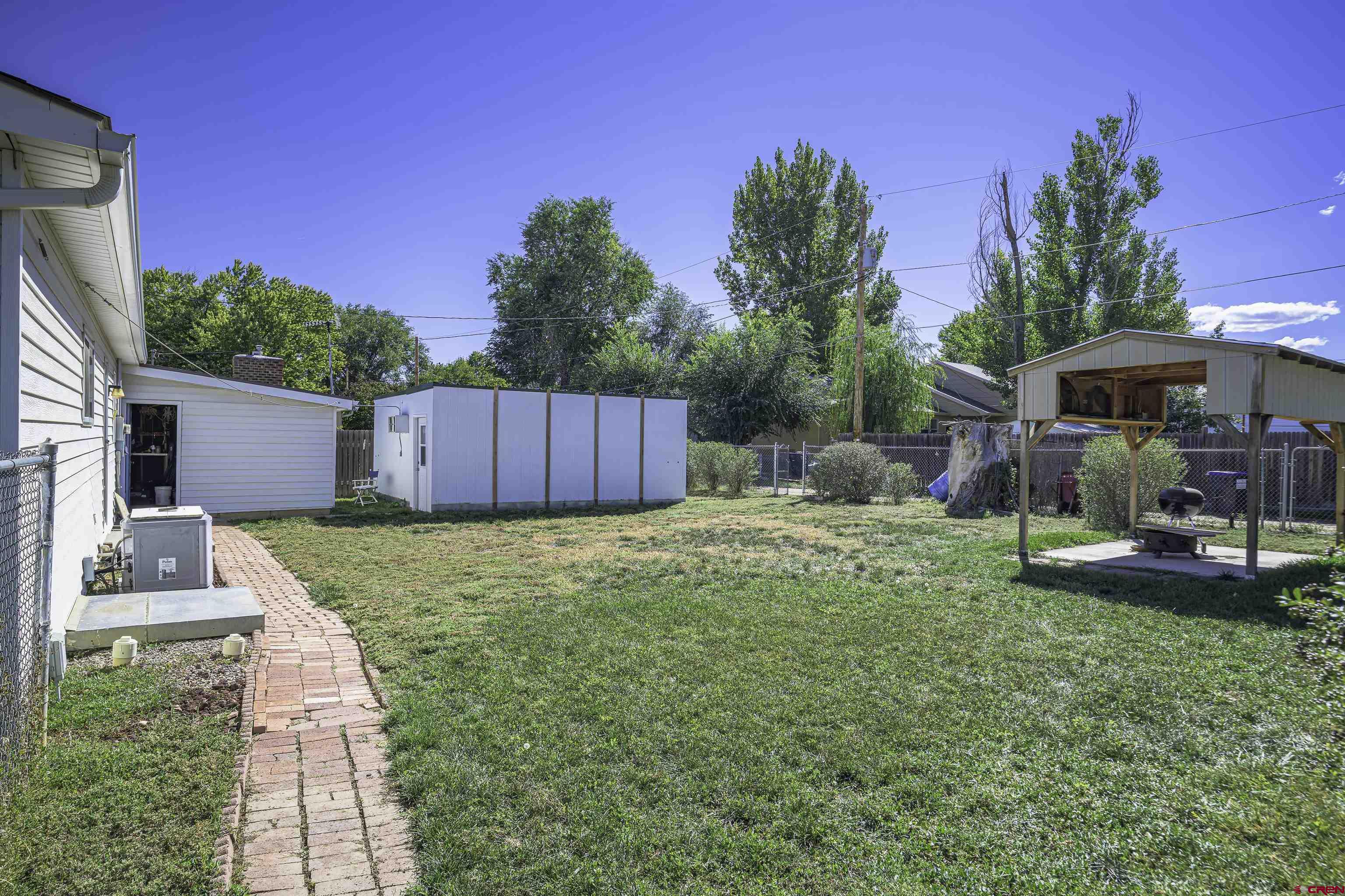 1002 East 2nd Street Florence, CO 81226 - Photo 29 of 44 a view of a backyard with a patio and fire pit