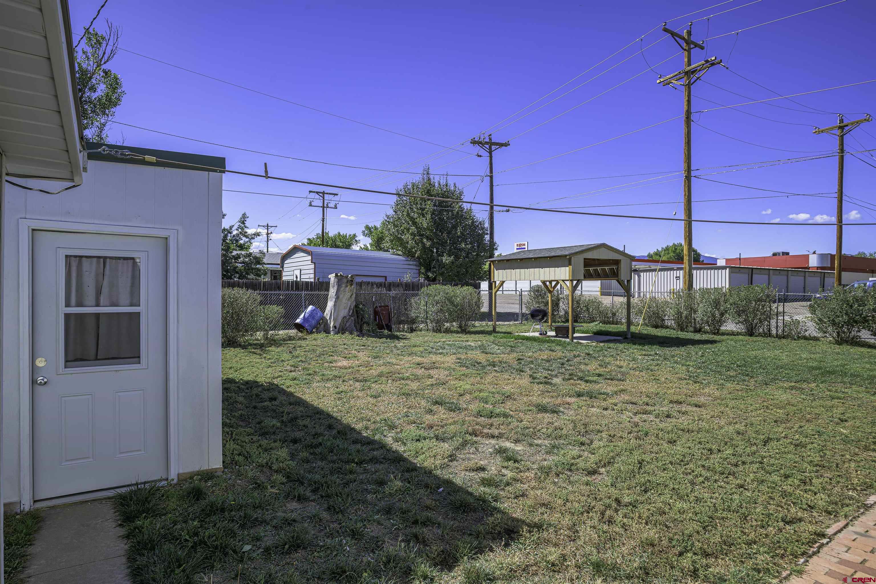 1002 East 2nd Street Florence, CO 81226 - Photo 31 of 44 a view of a house with backyard and sitting area