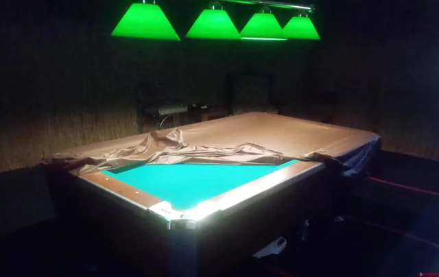 a bed sitting in a wooden room