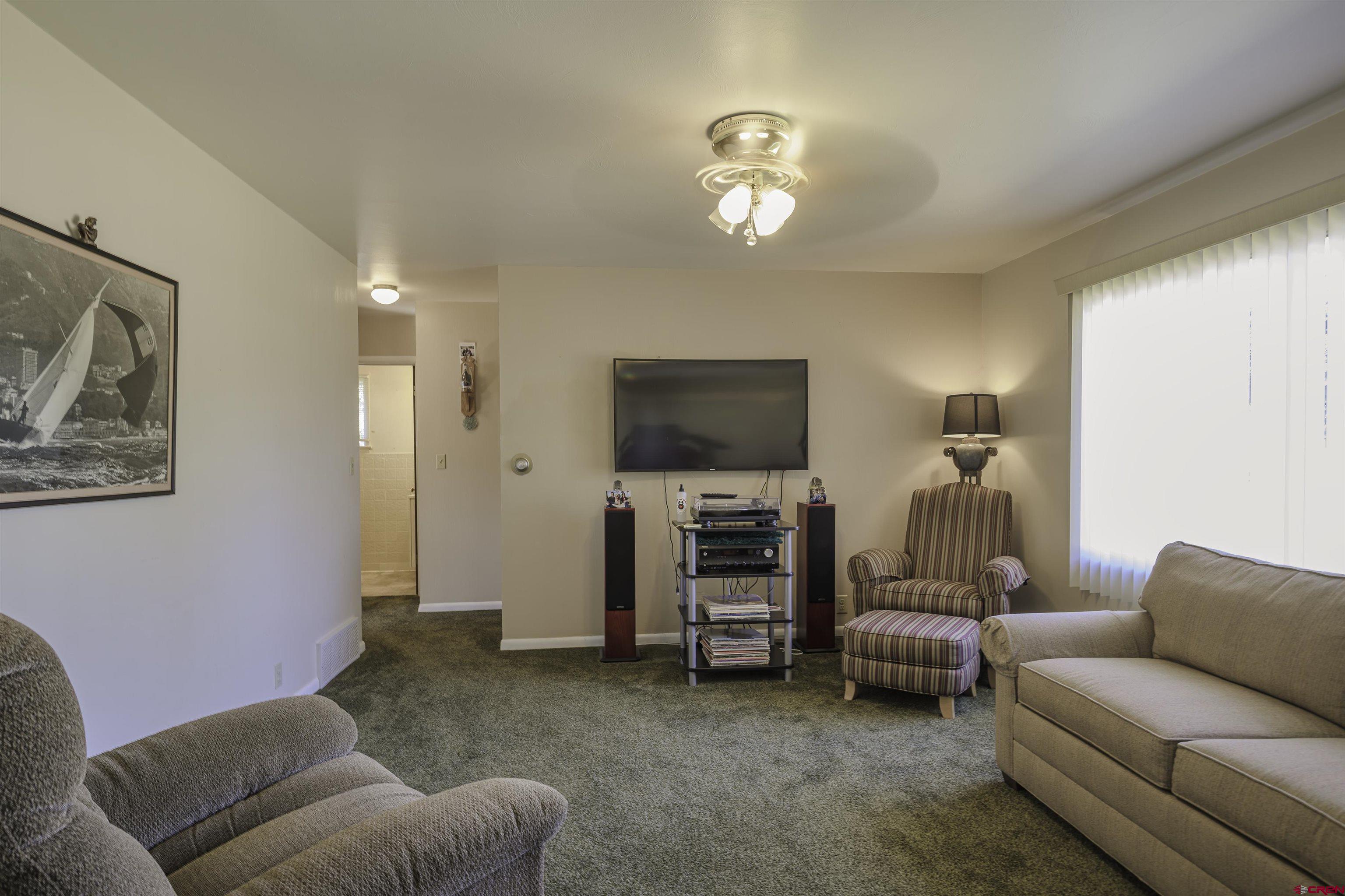 1002 East 2nd Street Florence, CO 81226 - Photo 4 of 44 a living room with furniture and a flat screen tv