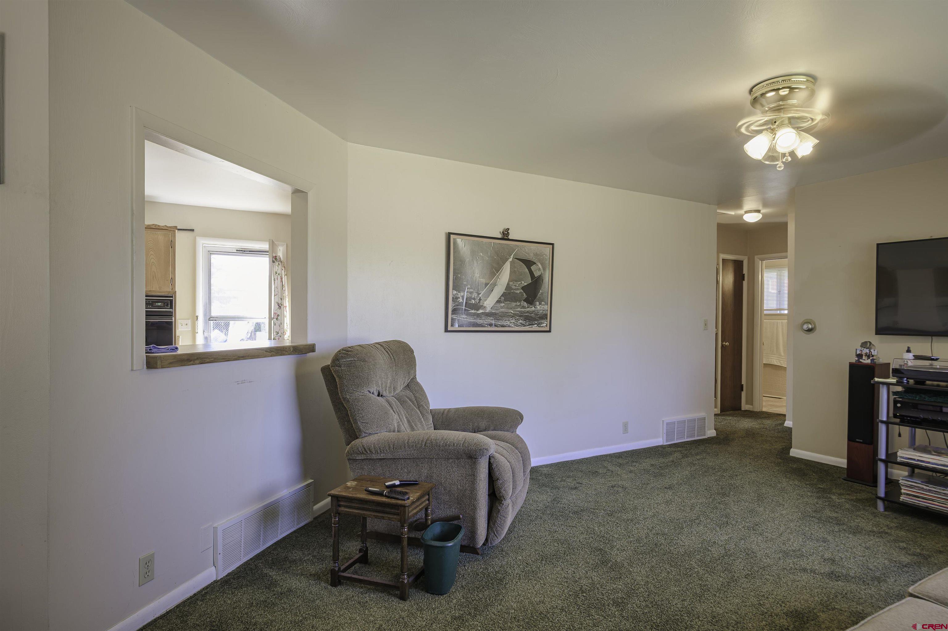 1002 East 2nd Street Florence, CO 81226 - Photo 6 of 44 a living room with furniture and a flat screen tv