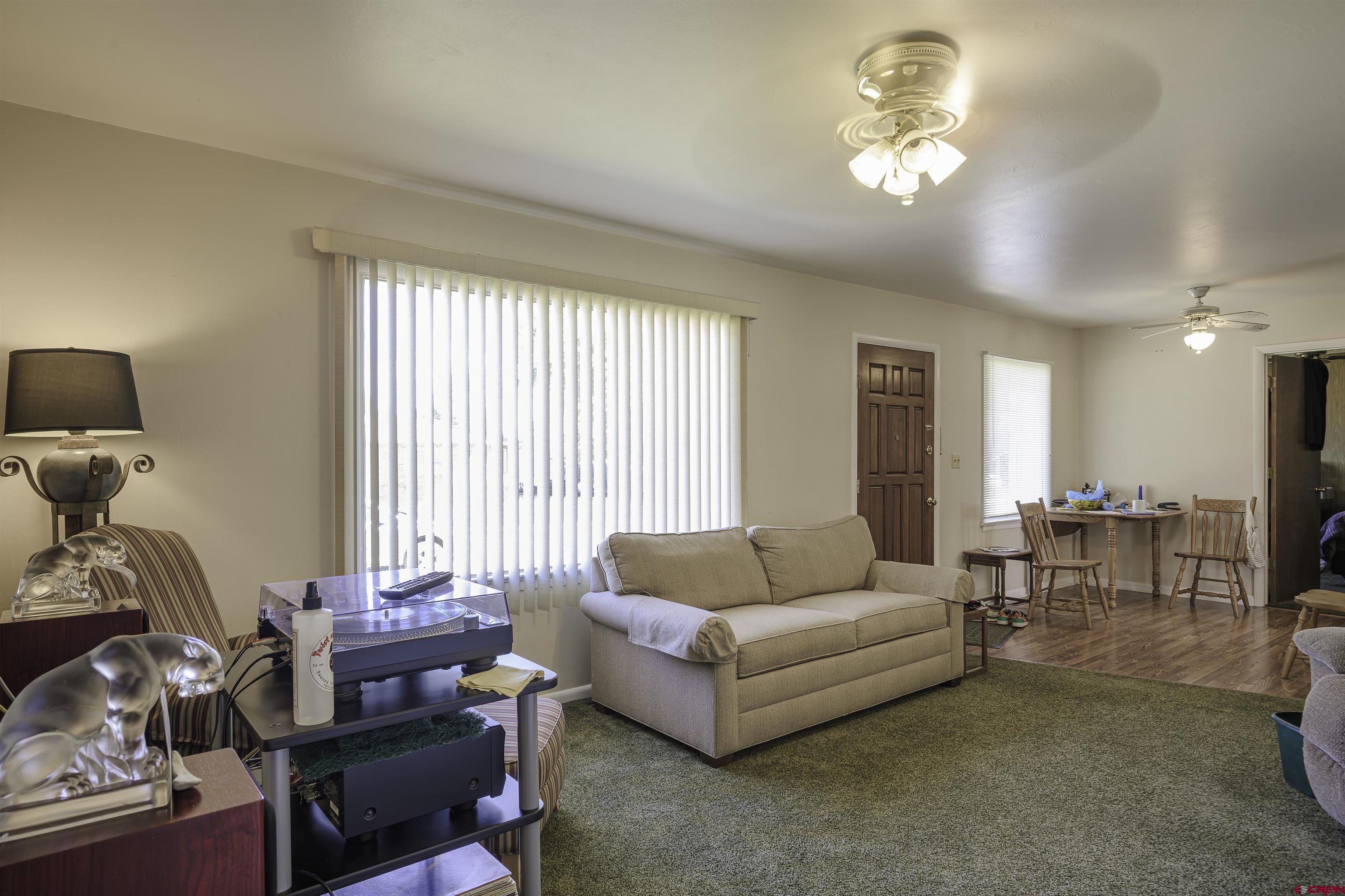 1002 East 2nd Street Florence, CO 81226 - Photo 8 of 44 a living room with furniture and wooden floor