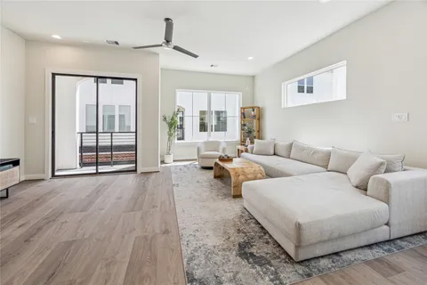 a living room with furniture and large window