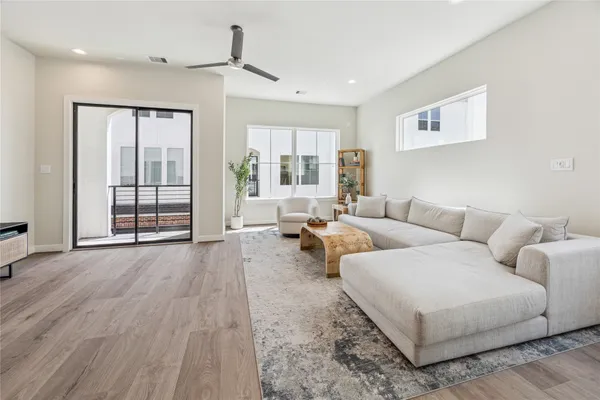 a living room with furniture and large window