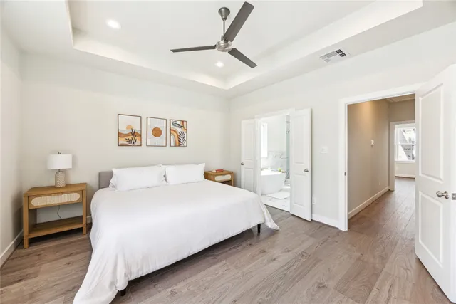 a bedroom with a bed and a chandelier