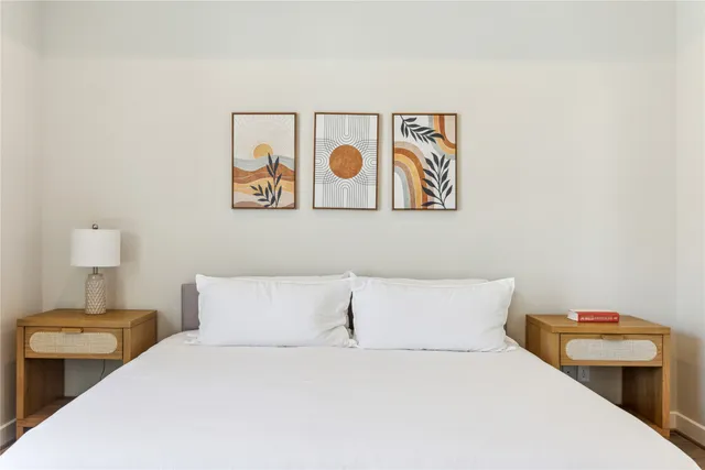 a bedroom with a bed and a wall painting