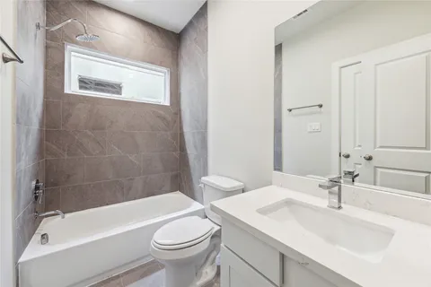 a bathroom with a sink a toilet and bathtub