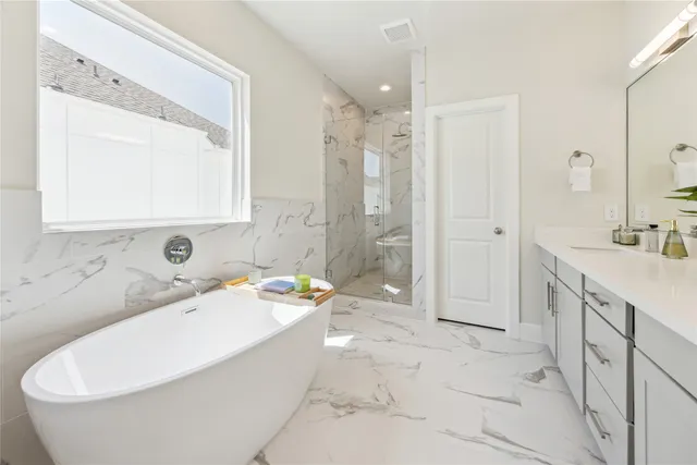 a bathroom with a tub a sink and a mirror