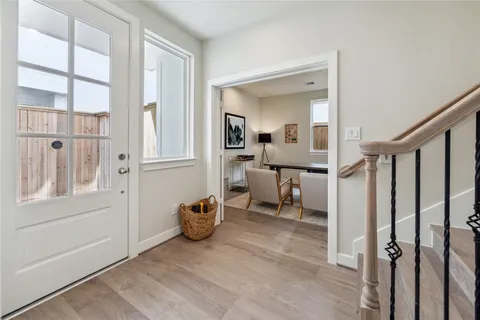 a view of a hallway with a livingroom and furniture
