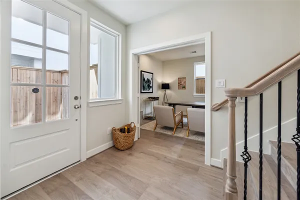 a view of a hallway with a livingroom and furniture