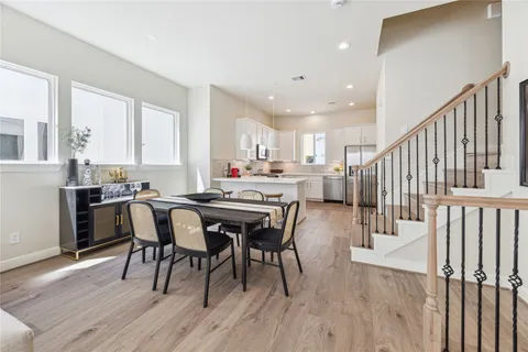 a dining room with furniture and wooden floor