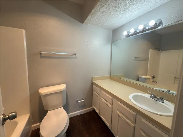 a bathroom with a sink toilet and a mirror