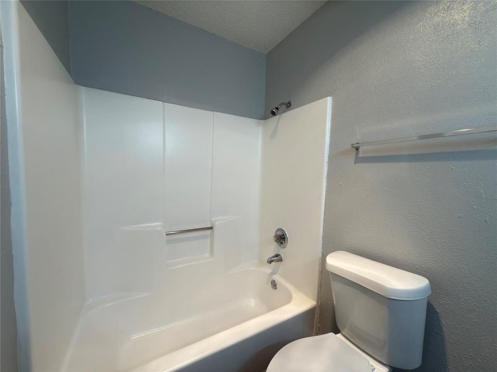 9696 Walnut Street, Unit 1108 Dallas, TX 75243 - Photo 16 of 19 a white toilet sitting next to a bath tub