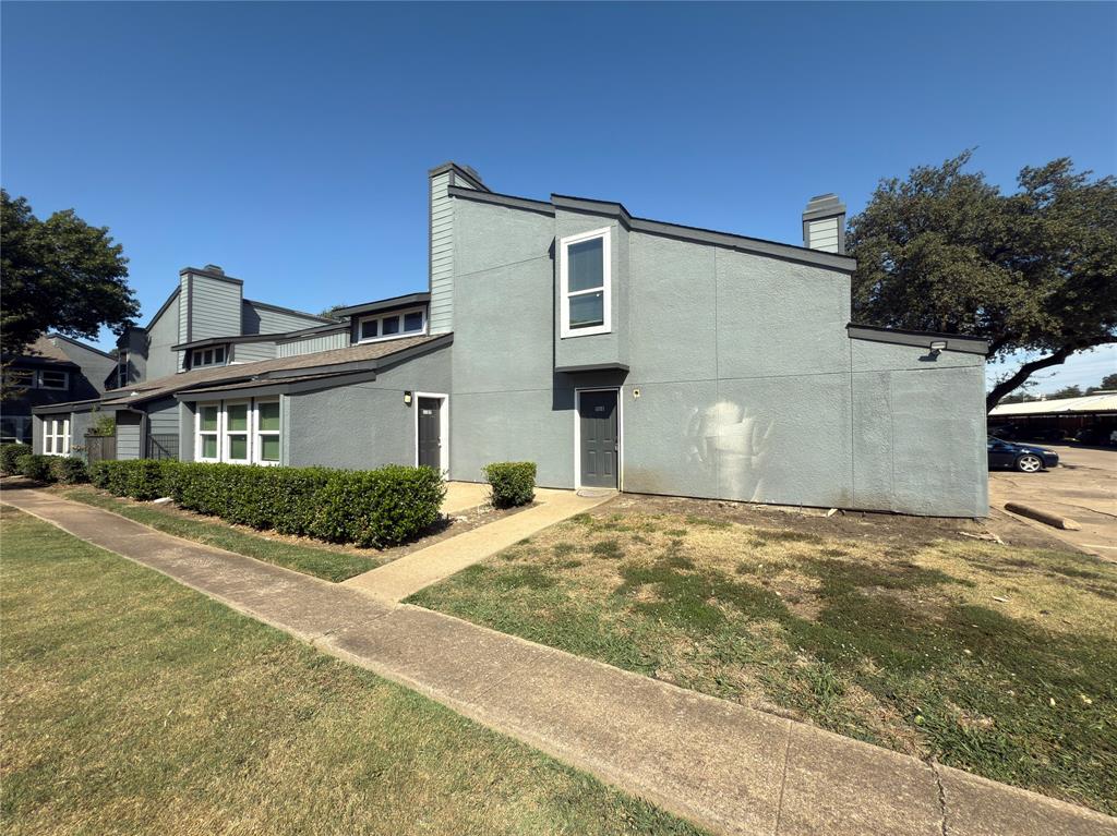 9696 Walnut Street, Unit 1108 Dallas, TX 75243 - Photo 2 of 19 a front view of a house with a yard and garage