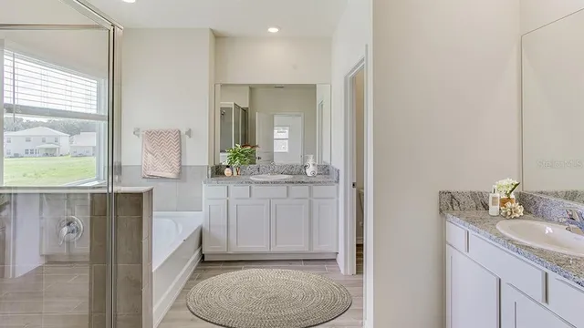a bathroom with a double vanity sink and mirror