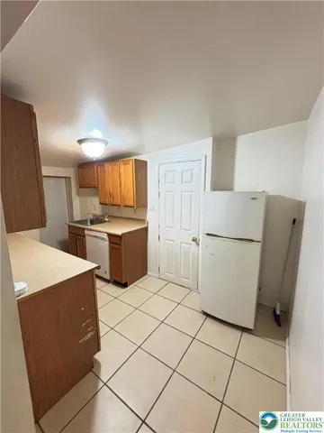 a kitchen with a refrigerator sink stove and cabinets