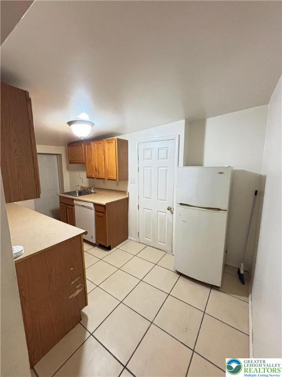 5562 Main Street, Unit 2 Whitehall, PA 18052 - Photo 4 of 19 a kitchen with a refrigerator sink stove and cabinets