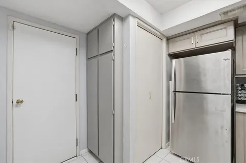 a white refrigerator freezer and a refrigerator in a kitchen