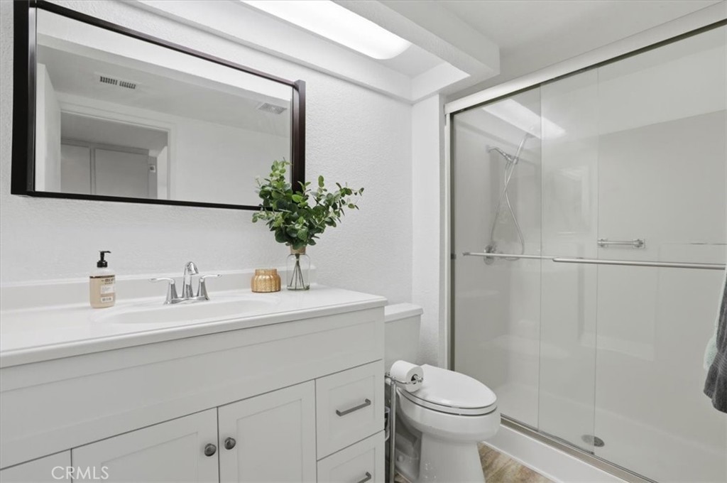 9743 La Jolla Drive, Unit D Rancho Cucamonga, CA 91701 - Photo 28 of 40 a bathroom with a sink a toilet and shower