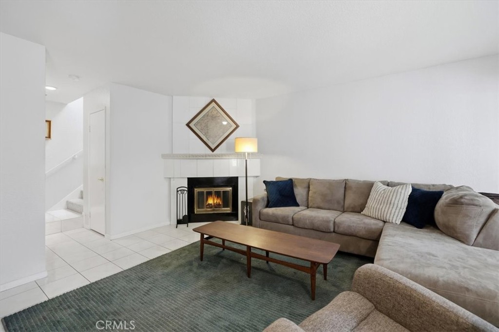 9743 La Jolla Drive, Unit D Rancho Cucamonga, CA 91701 - Photo 9 of 40 a living room with furniture a fireplace and a table