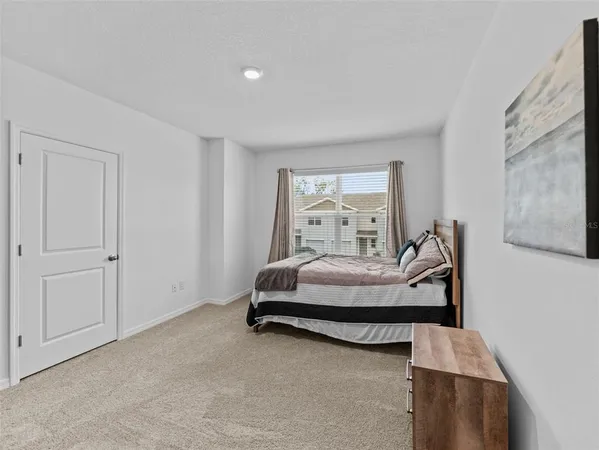 a bedroom with bed and window